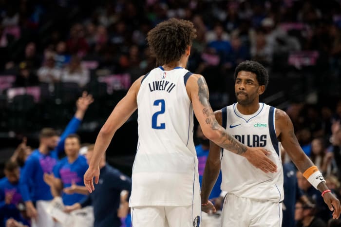 Dallas Mavericks' Dereck Lively II and Kyrie Irving celebrating after a play.